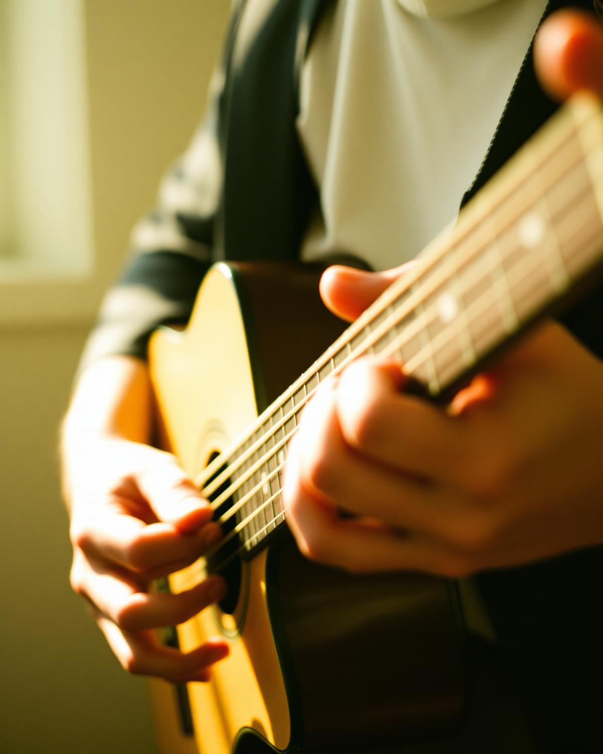 Hands playing acoustic guitar